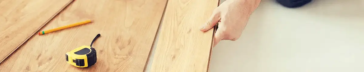 A professional installing wood flooring in Akron, OH