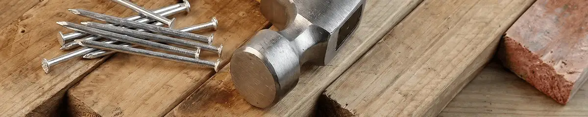 Hammer and nails on hardwood flooring boards in Akron, OH