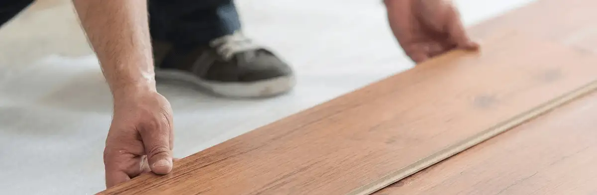 A professional installing laminate flooring in Akron, OH