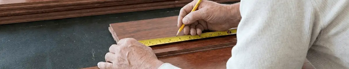 A professional installing wood flooring in Akron, OH